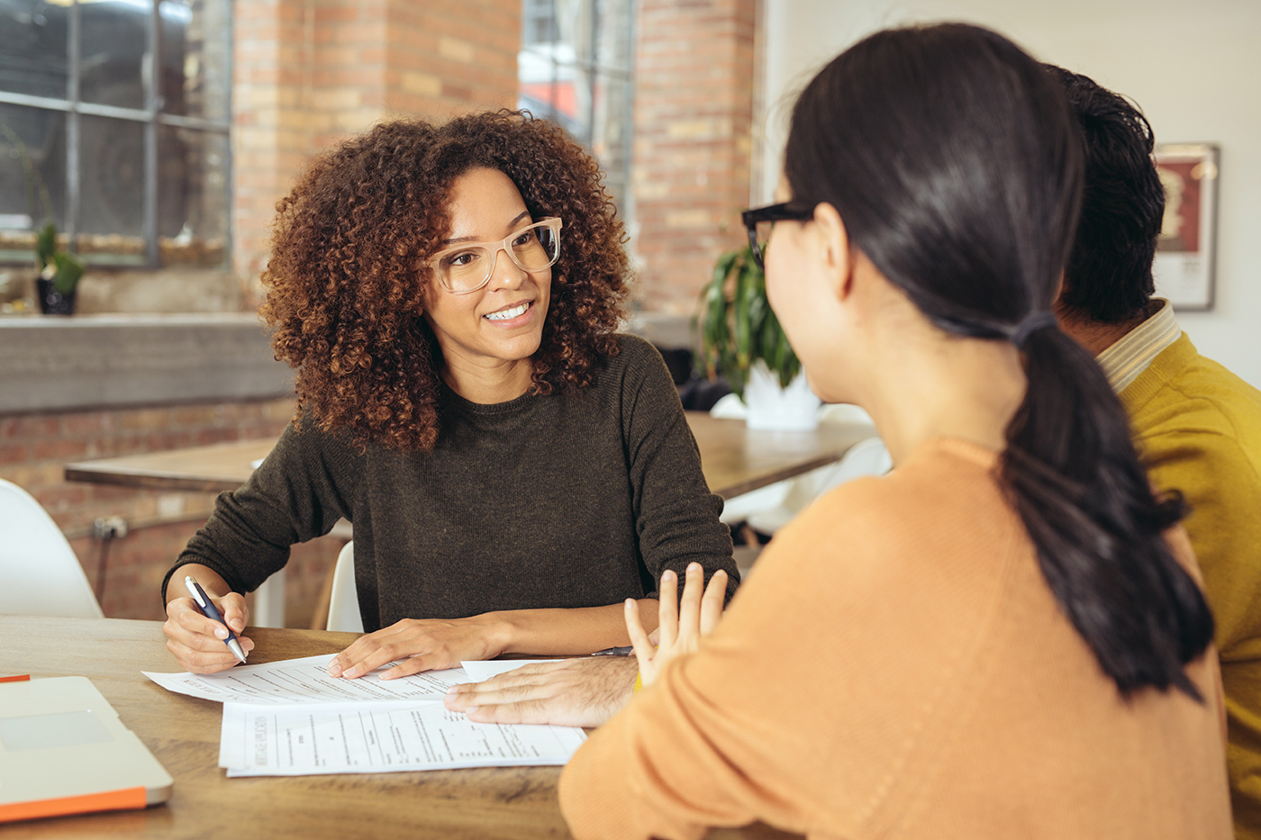 Financial advisor reviewing report with couple