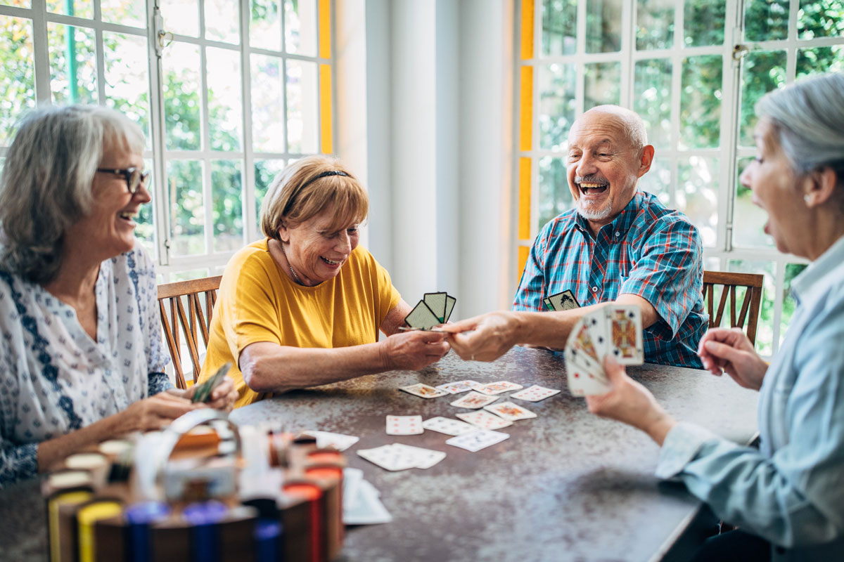 Four friends playing a card game